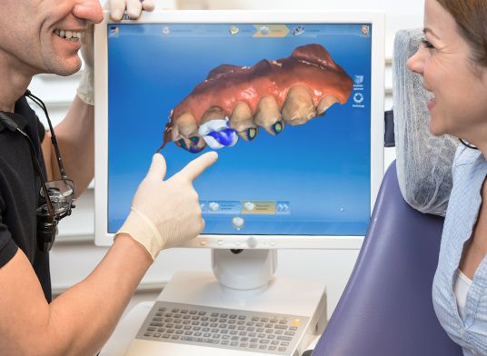 Doctor showing patient dental software